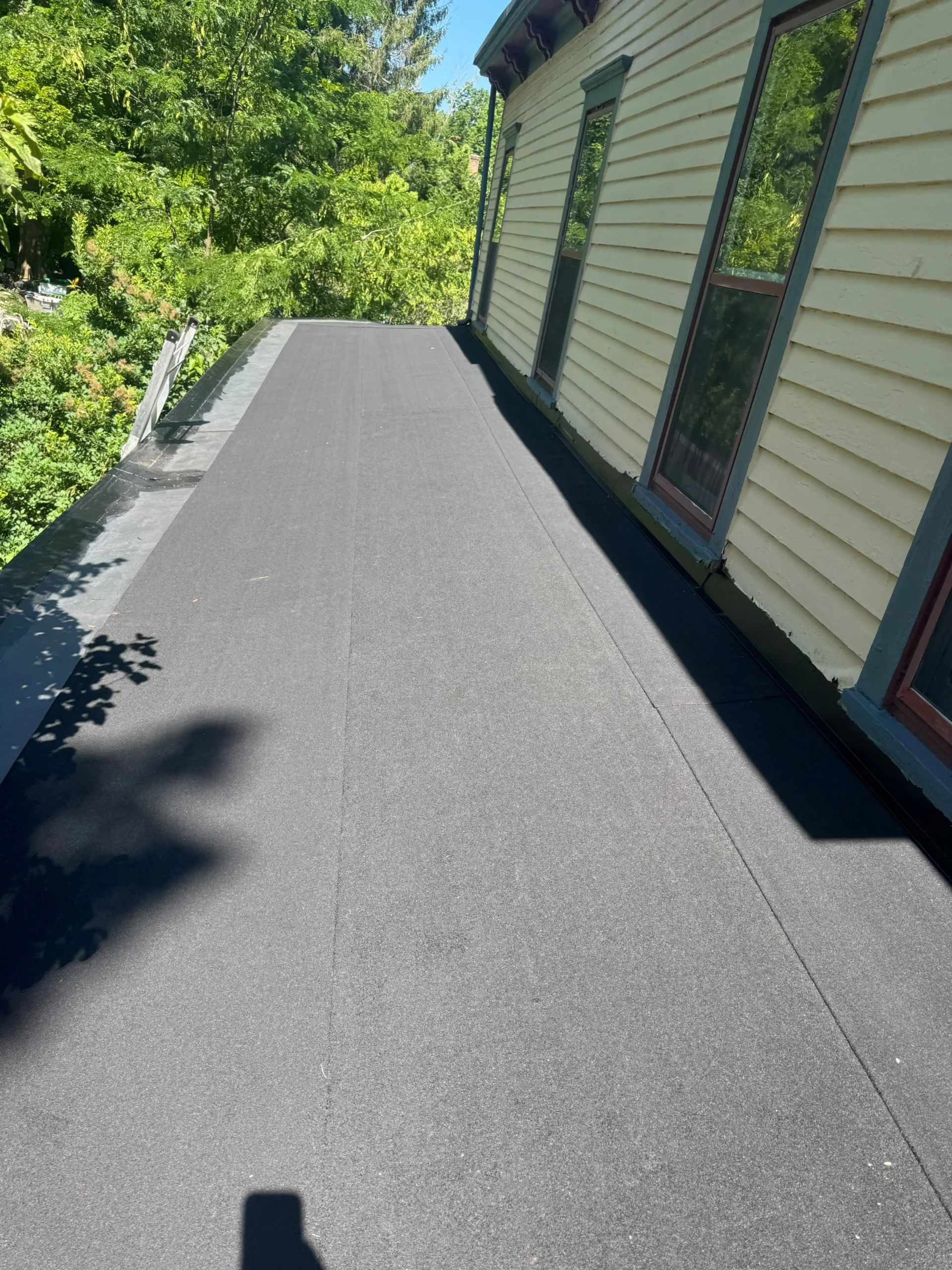Completed asphalt shingle roof replacement on a New Jersey home